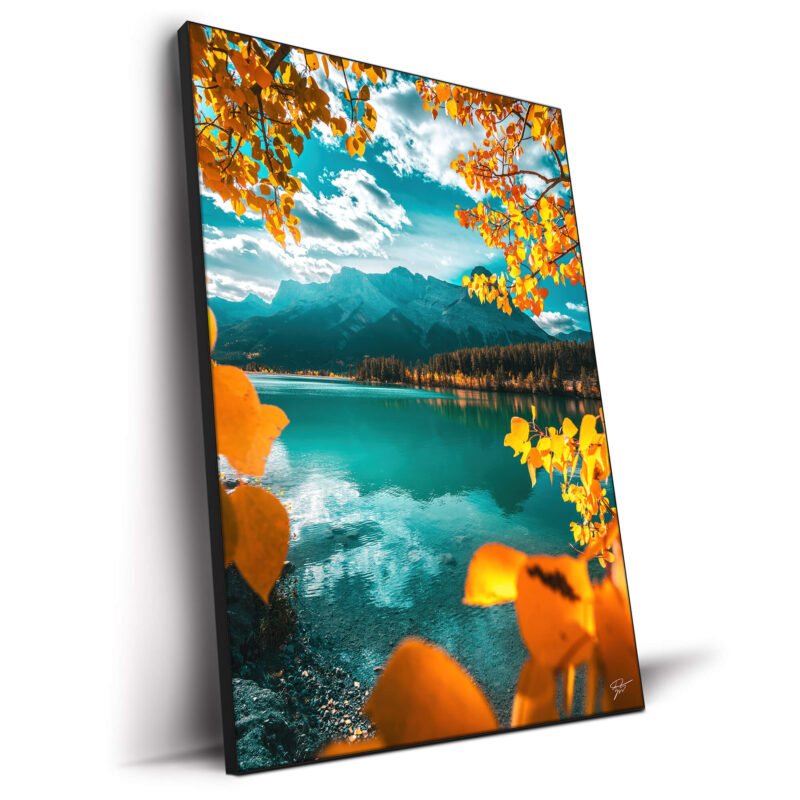 Autumn in Banff National Park, Alberta, with a turquoise lake, snow-capped mountains, and vibrant golden leaves.