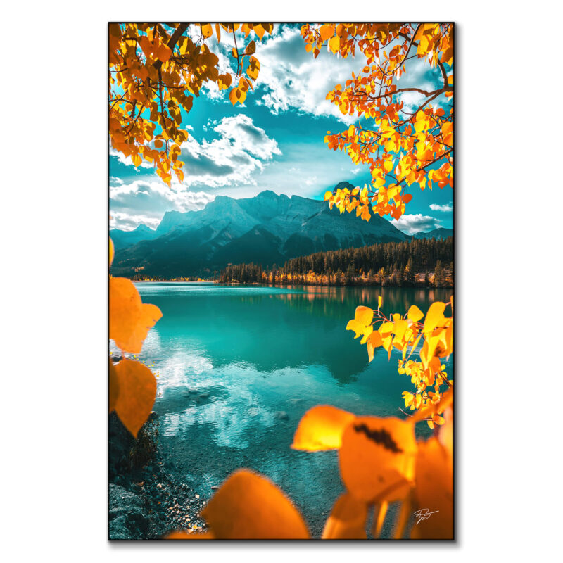 Autumn in Banff National Park, with a turquoise lake, snow-capped mountains, and vibrant golden leaves.