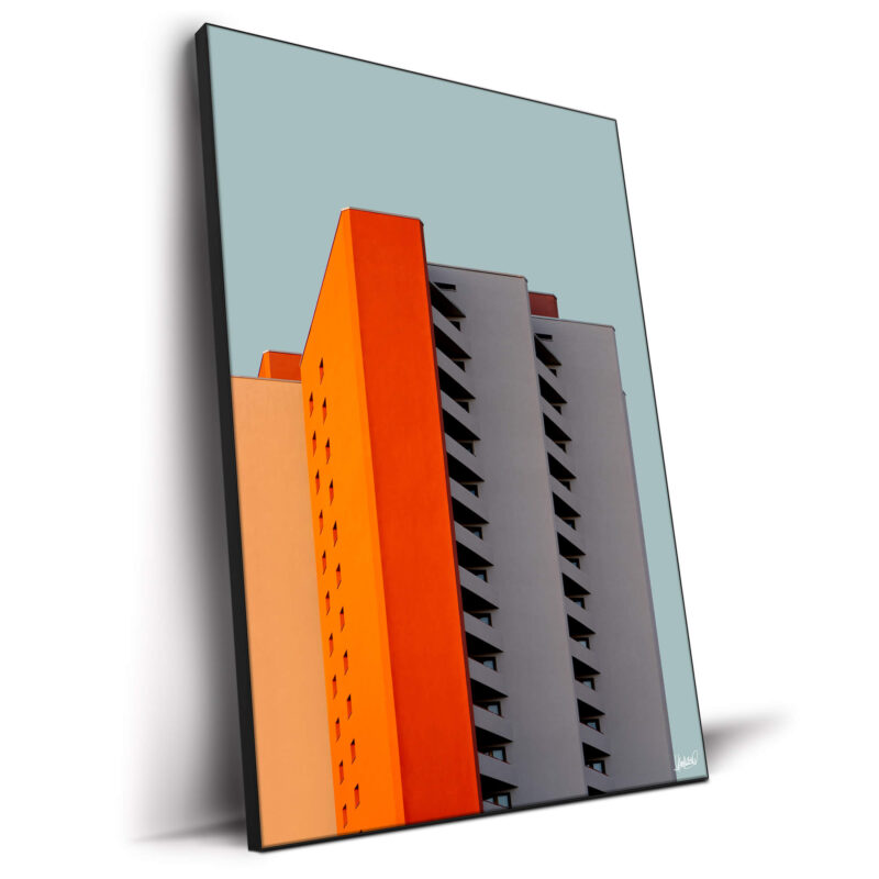 High-rise building with orange, gray, and peach facade, showcasing modern design.