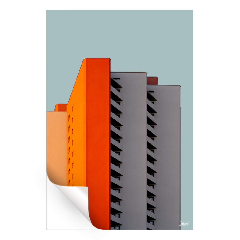 Building with orange, gray, and peach facade, showcasing modern design.