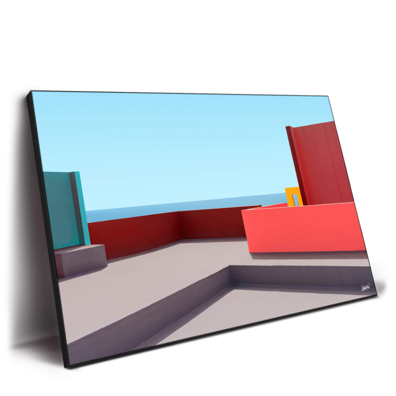 Terrace with red, blue, and yellow walls overlooking the sea, showcasing minimalist design.