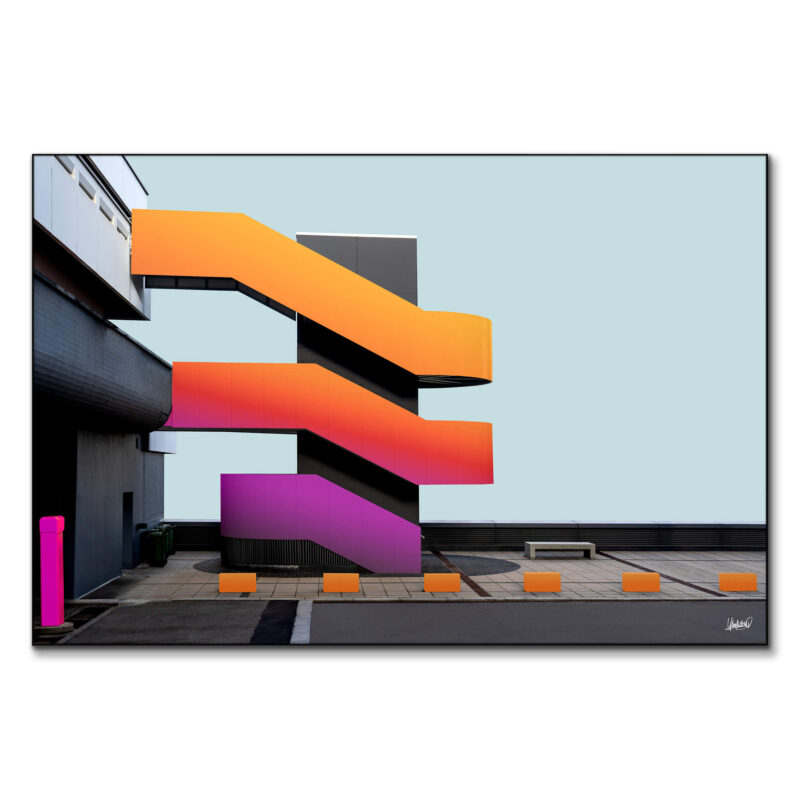 Bold staircase with vibrant orange and pink hues, set against a dark building background.