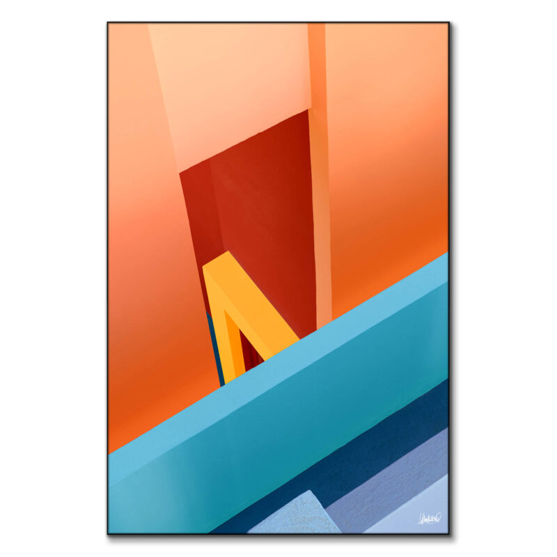 Vibrant building in vivid orange, yellow, and turquoise, creating an abstract geometric composition.