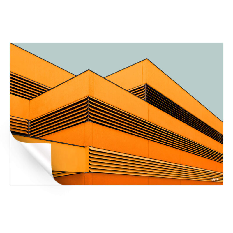 Building facade with orange panels and black slats in a pattern against a gray-blue background.