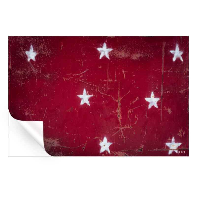 distressed white stars on a bold red background, combining rustic charm with a classic Americana feel.