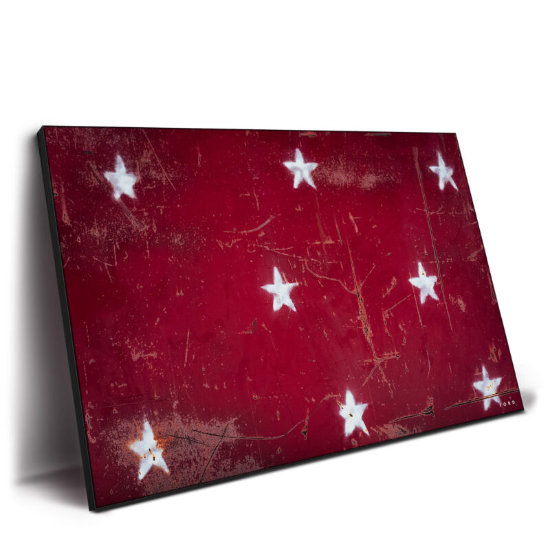 distressed white stars on a bold red background, combining rustic charm with a classic Americana feel.