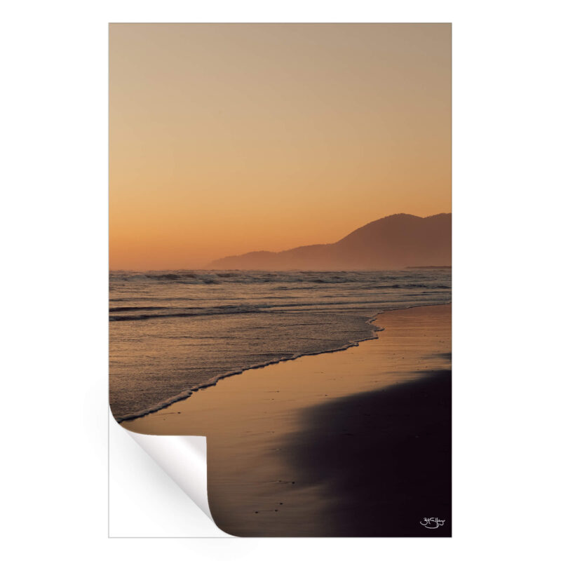 Vibrant sunset over the ocean with soft colors reflecting on the water.