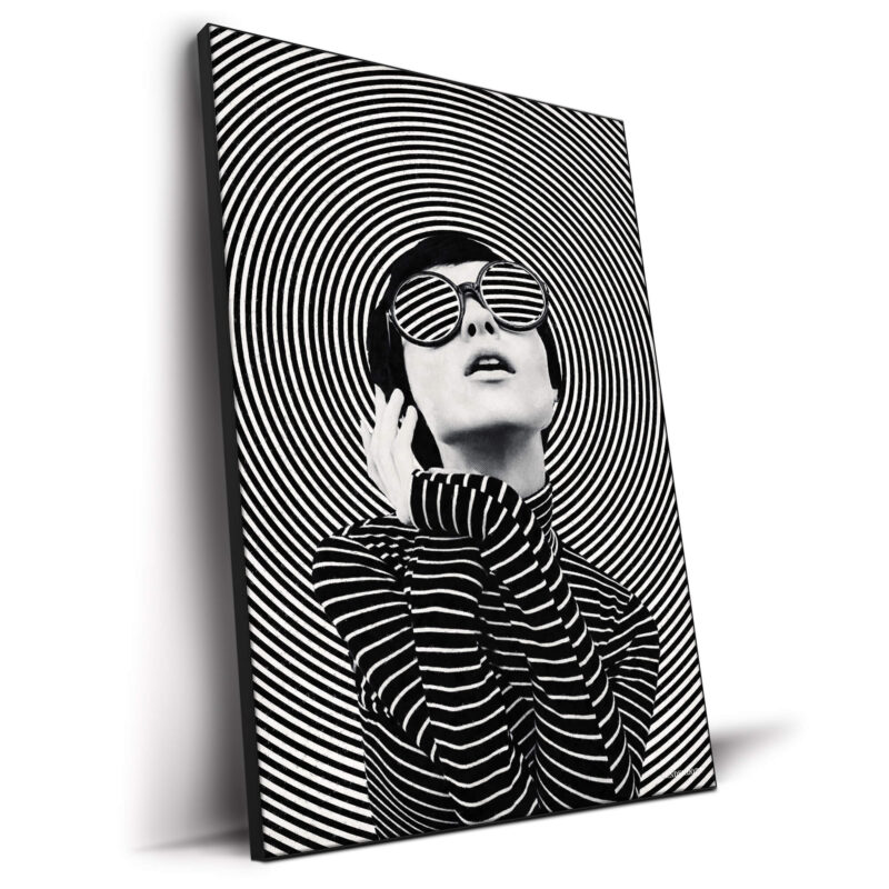 A woman in sunglasses poses in front of concentric black and white circles, creating a dynamic and fashionable artwork.