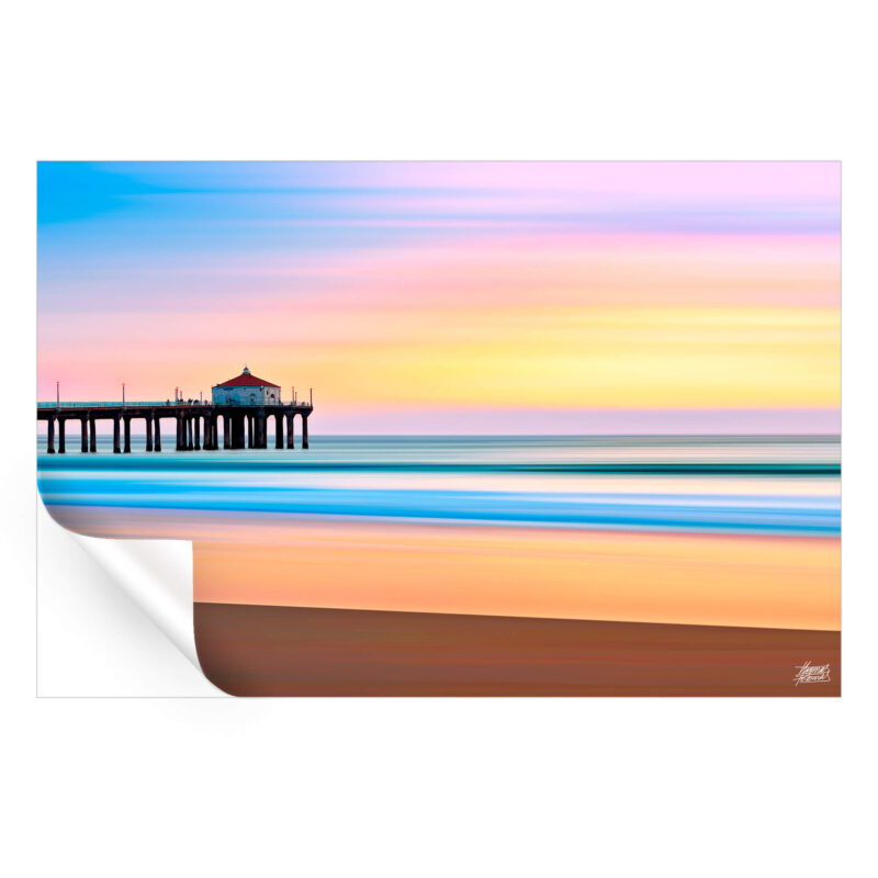 The Manhattan Beach Pier during sunset, with vibrant colors reflecting on the water, creating a serene beach atmosphere.