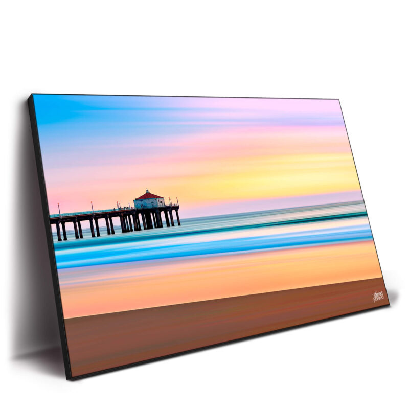 The Manhattan Beach Pier during sunset, with vibrant colors reflecting on the water, creating a serene beach atmosphere.