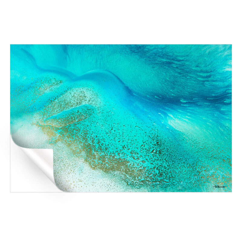 Tropical blue sea water meeting the shore with calming blue and white hues.