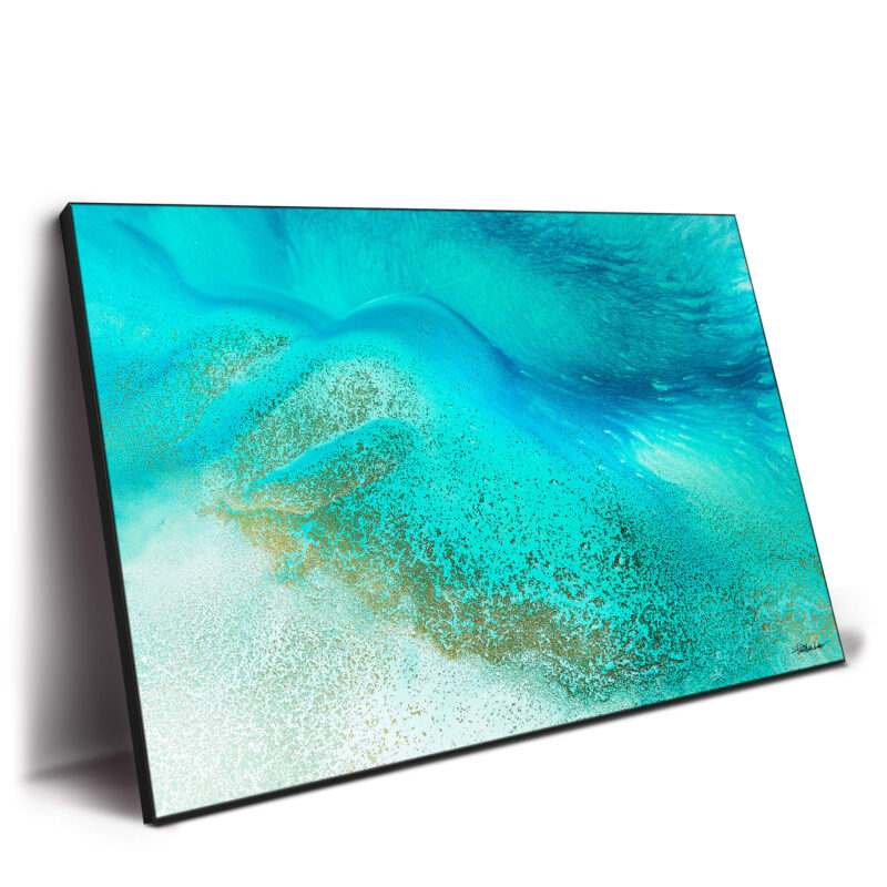 Tropical blue sea water meeting the shore with calming blue and white hues.