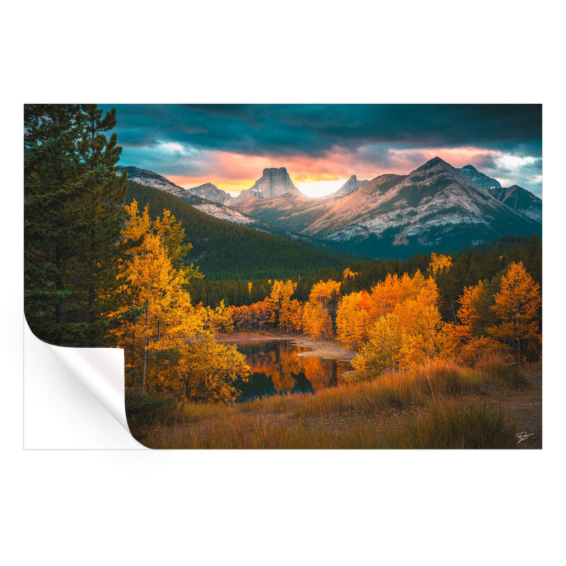 Autumn mountain range at sunset with vibrant golden foliage.