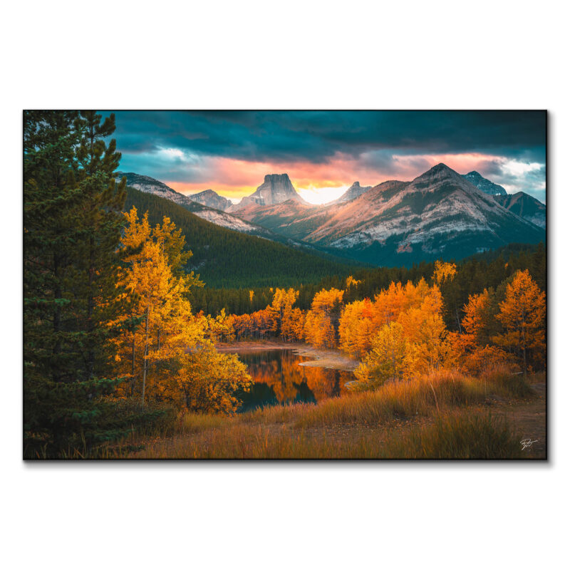 Autumn mountain range at sunset with vibrant golden foliage.