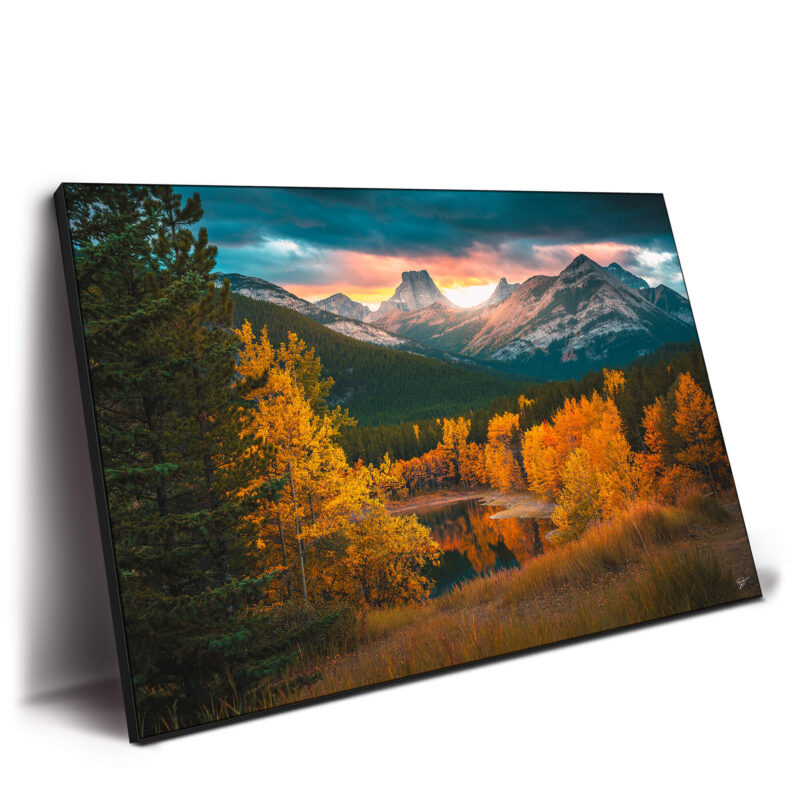 Autumn mountain range at sunset with vibrant golden foliage.