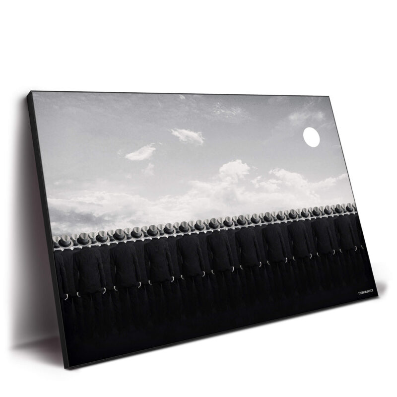 Surreal men in black suits standing in uniform against a white sky with a large moon, evoking a sense of mystery and eerie symmetry.